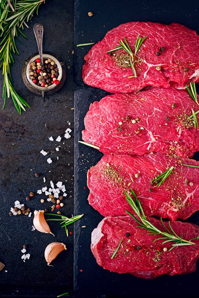 raw-beef-steaks-with-spices-rosemary-flat-lay-top-view 1